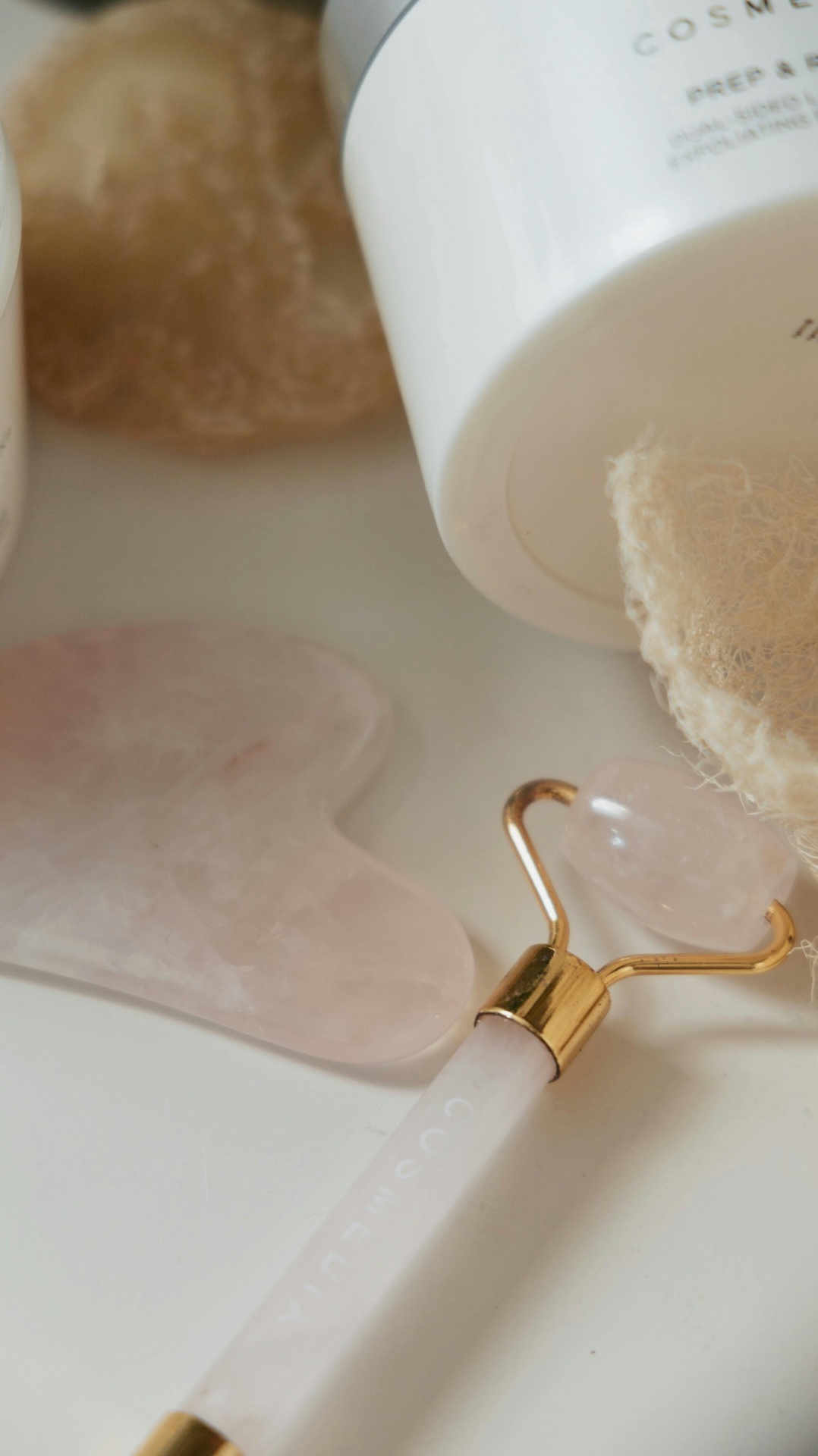 Woman using jade roller on her face