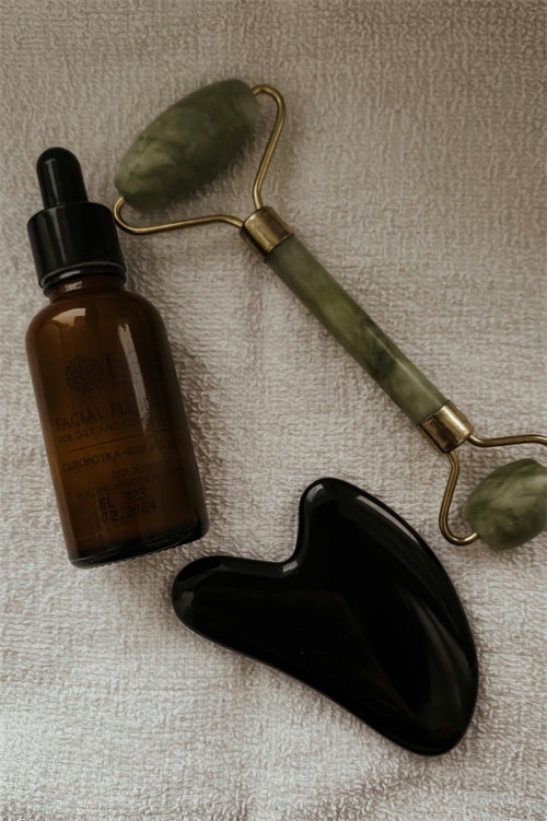 Jade massage roller on natural stone surface