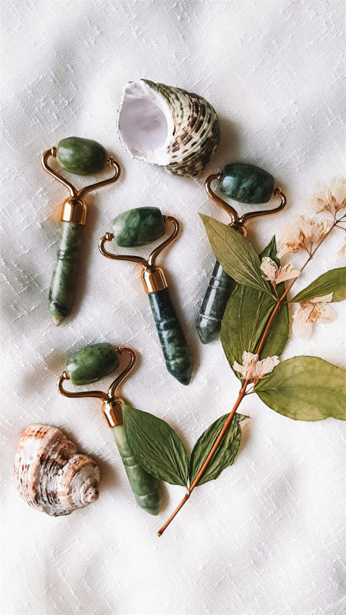 Jade roller on forehead and temples