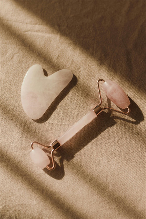 Jade roller positioned along the jawline for sculpting massage