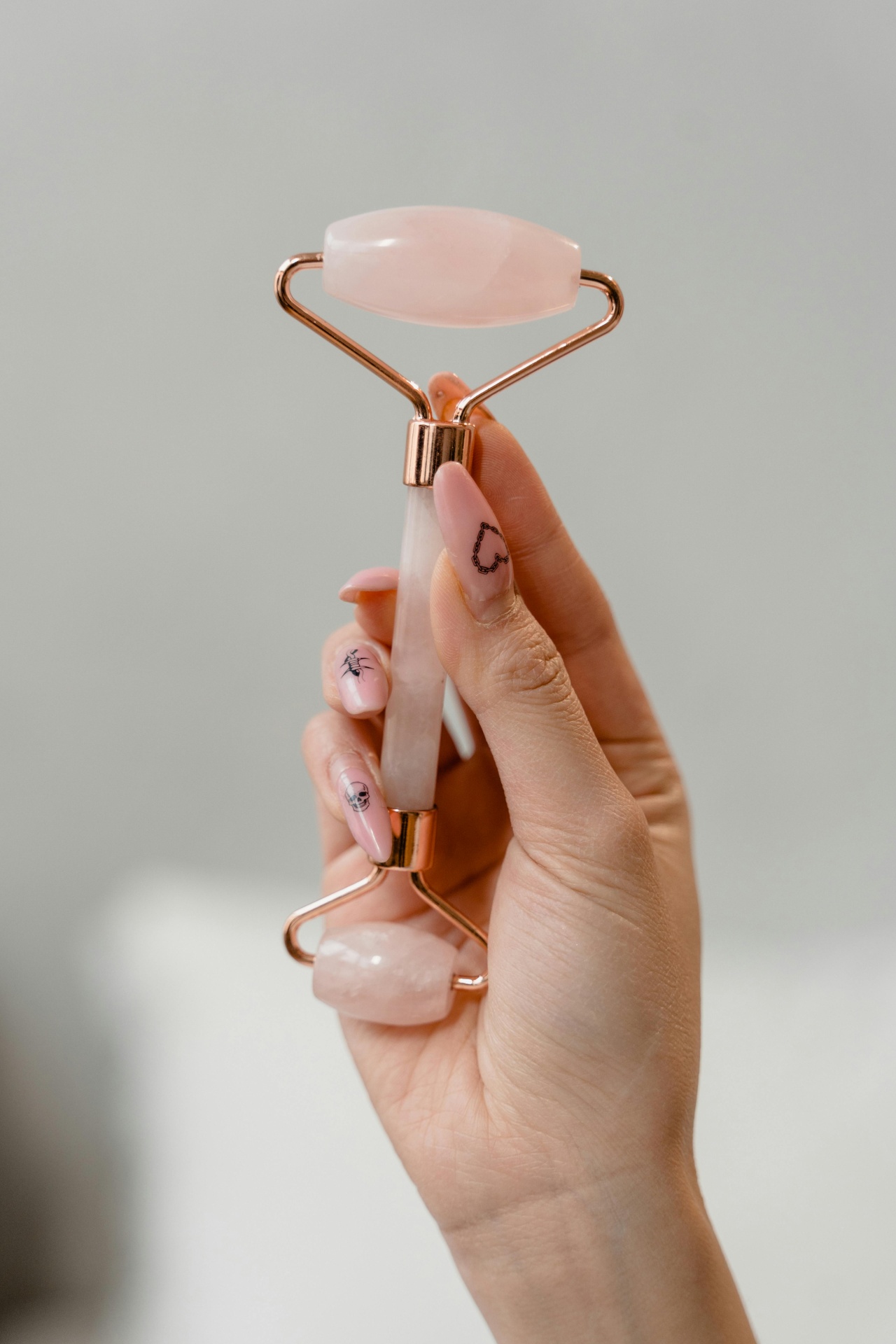 Close-up of jade roller on skin showing blood circulation effect