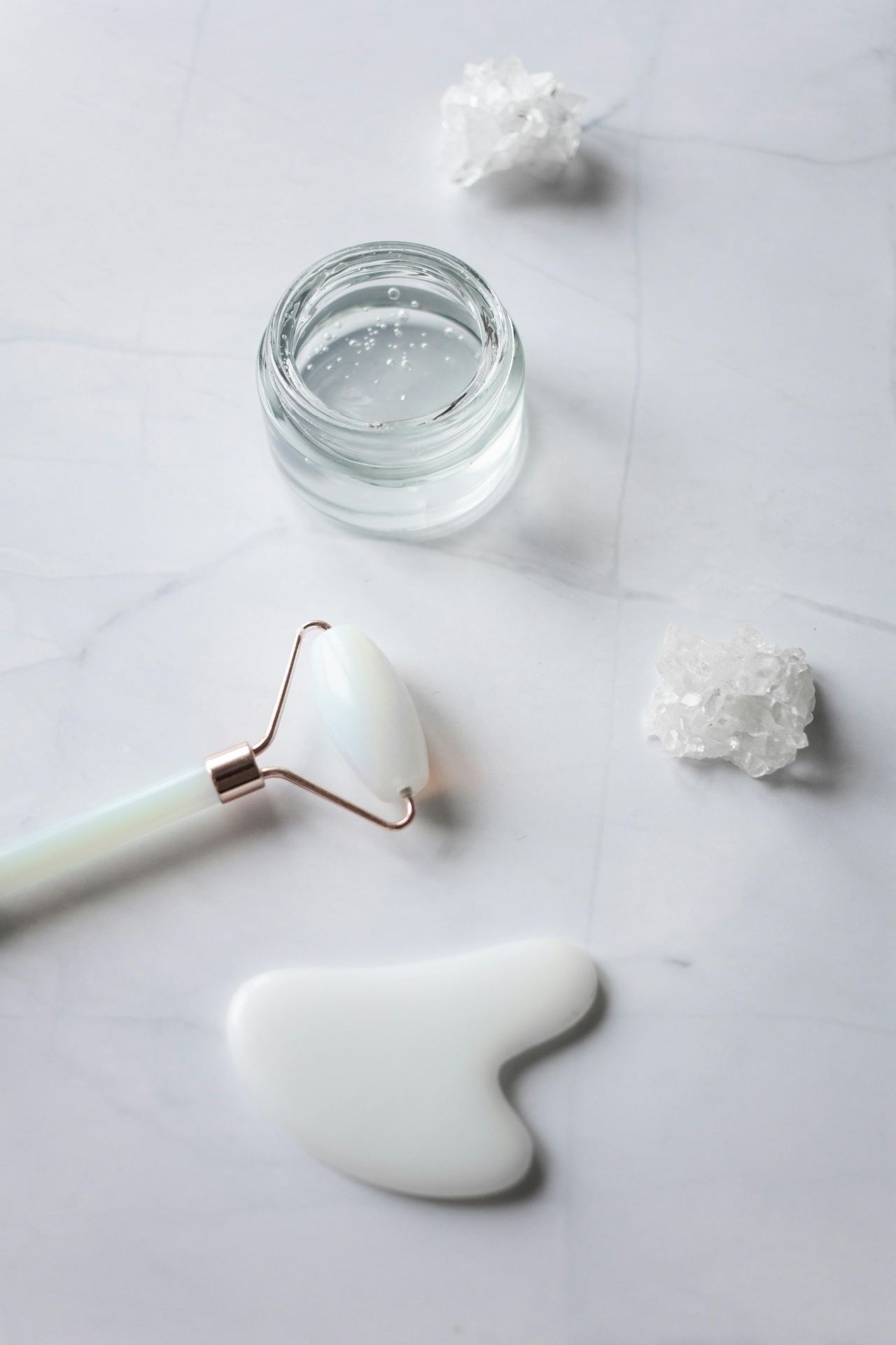 Jade roller on a skincare vanity with night serums