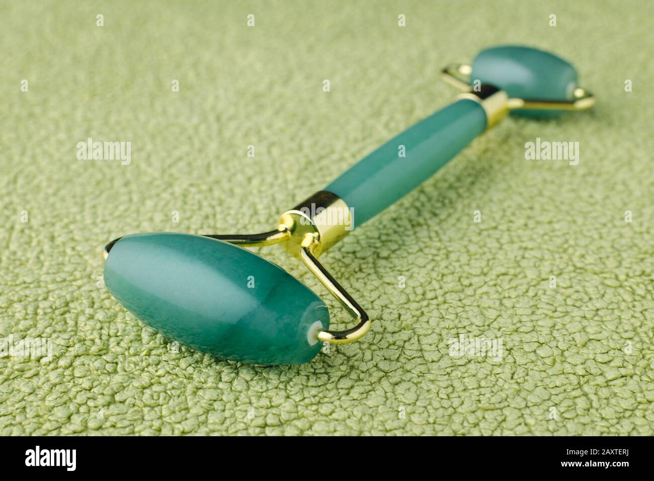 Jade roller and amethyst crystal used for facial massage