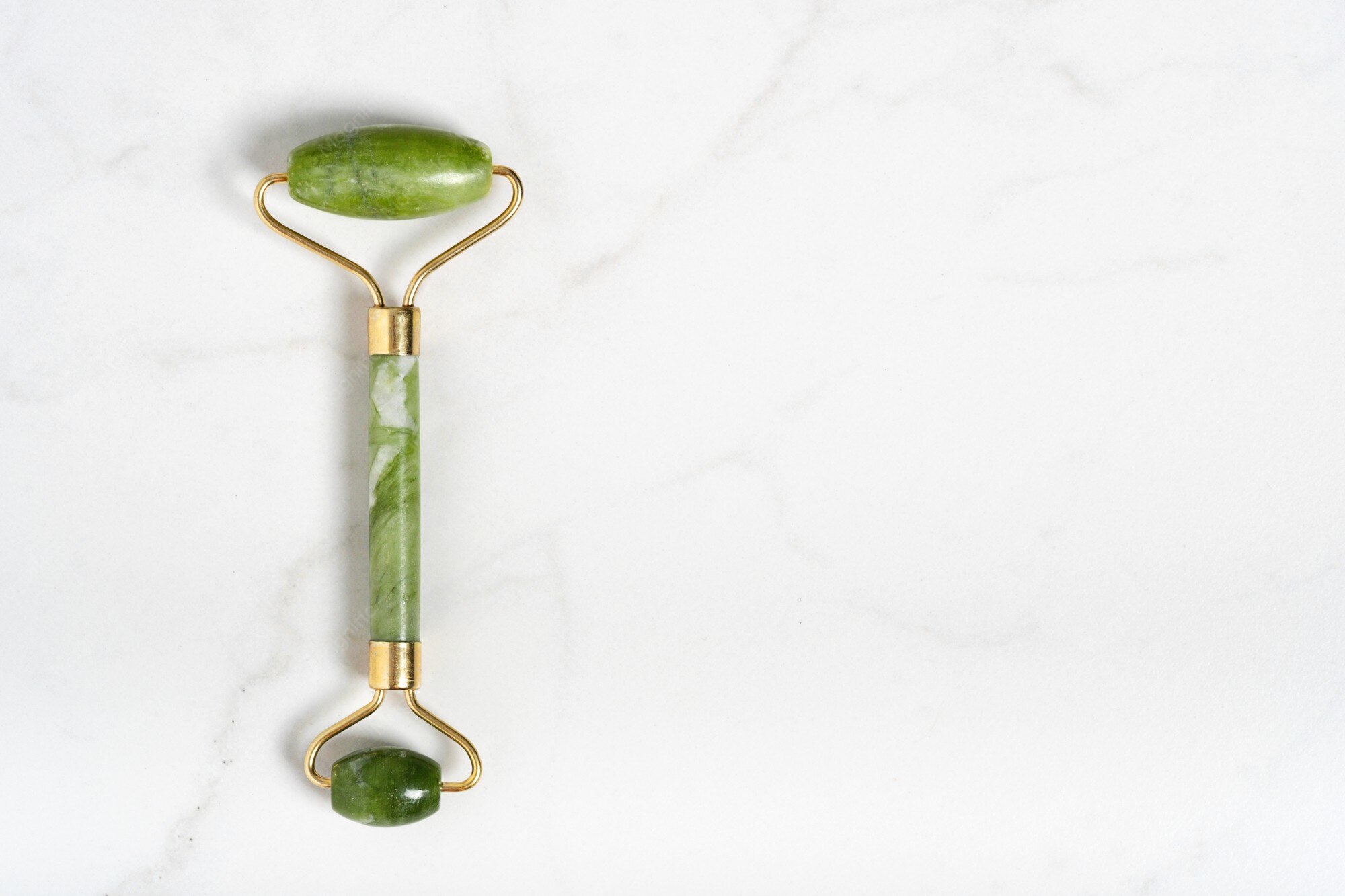 Jade roller applied to temple acupressure point on face