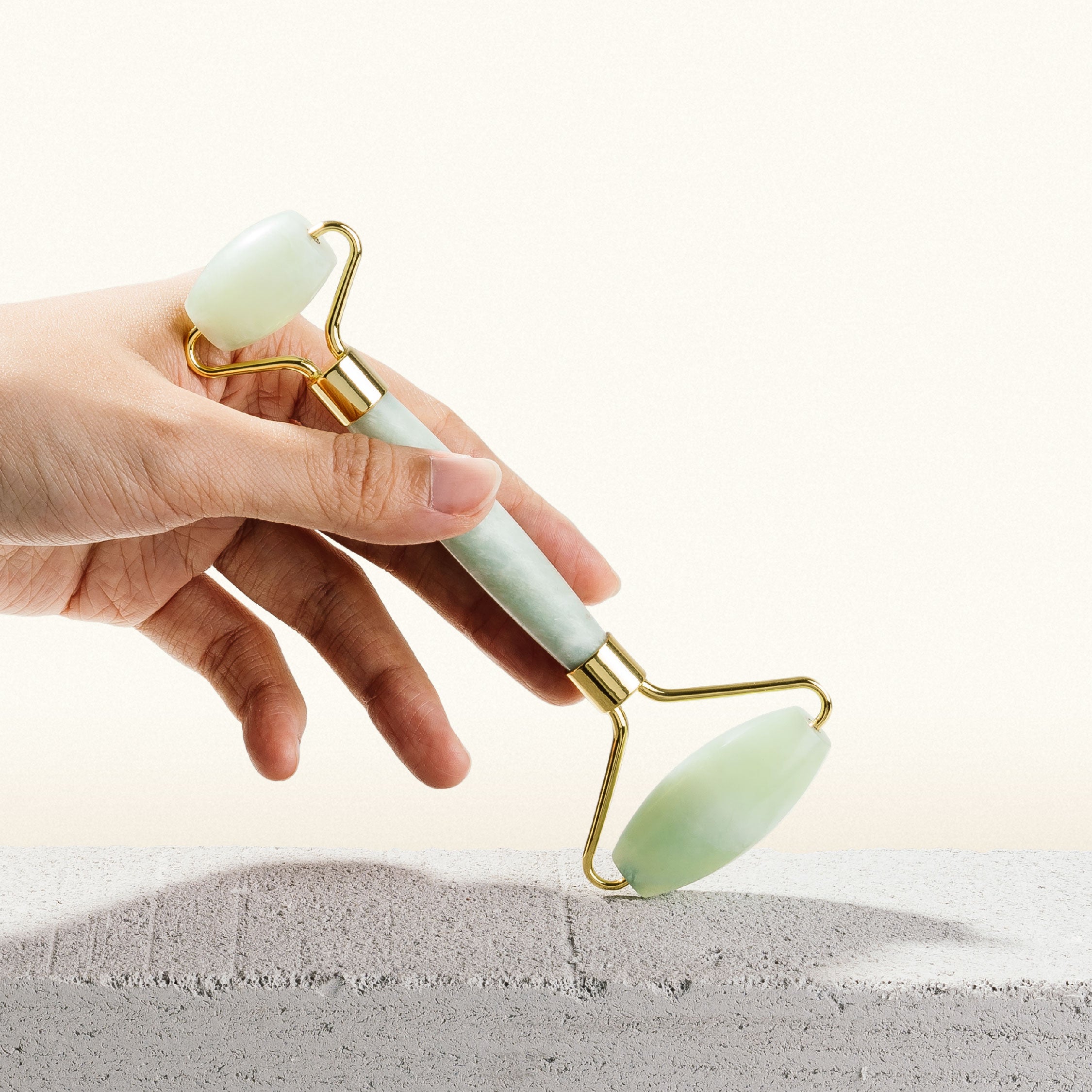 Jade roller resting on a pregnancy-safe skincare shelf next to a hyaluronic acid serum