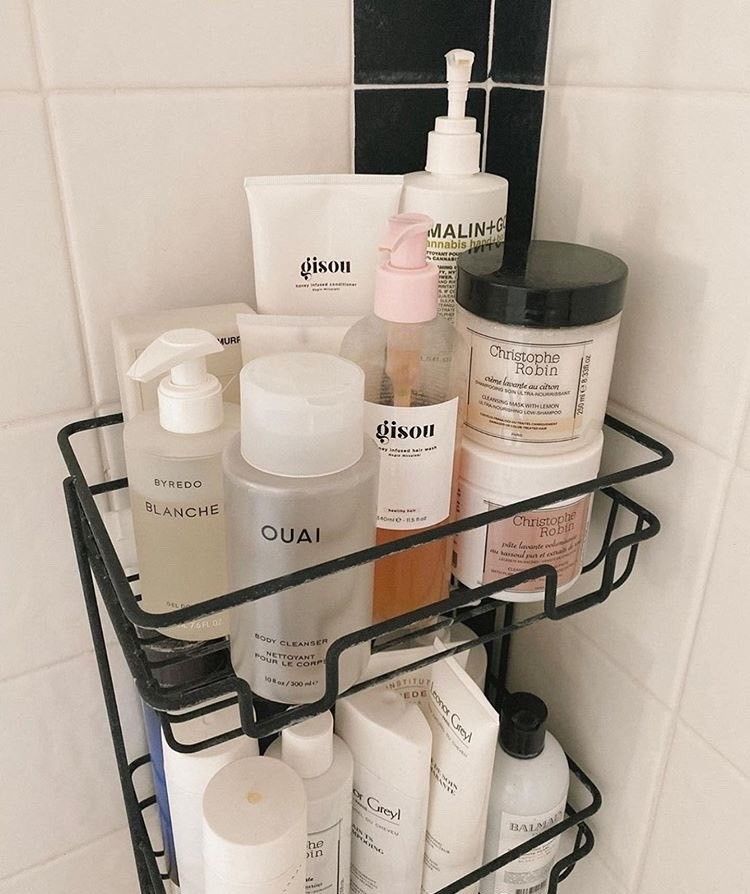 A jade roller and an anti-aging skincare lineup on a bathroom shelf