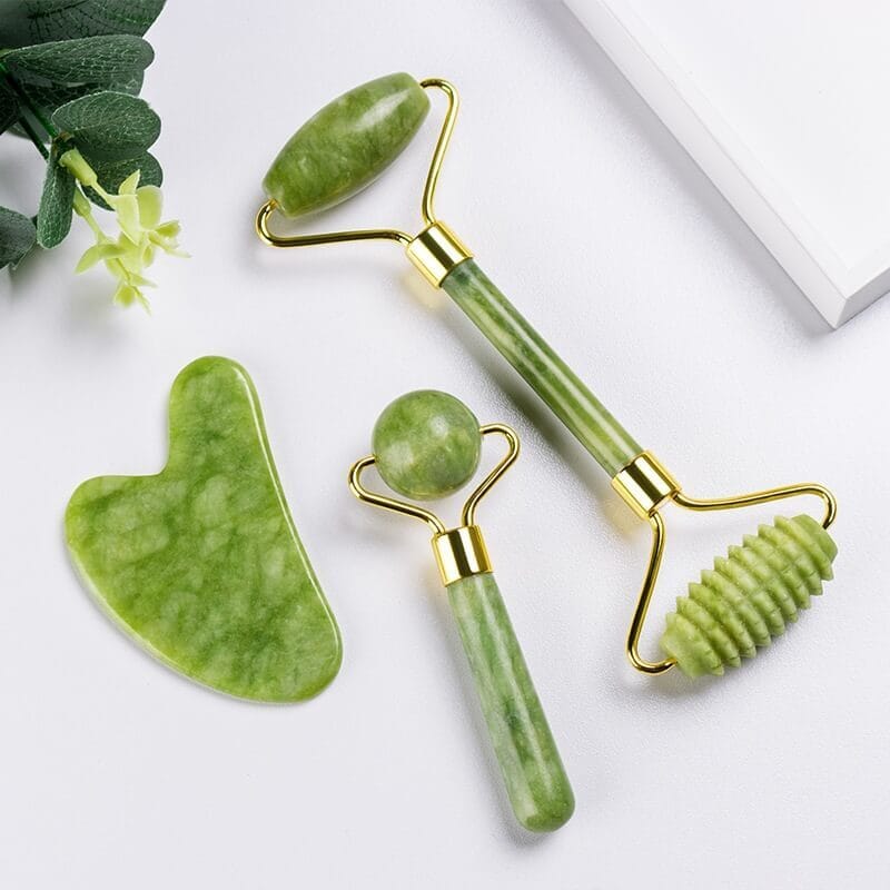 A jade roller on a drugstore shelf next to other skincare tools