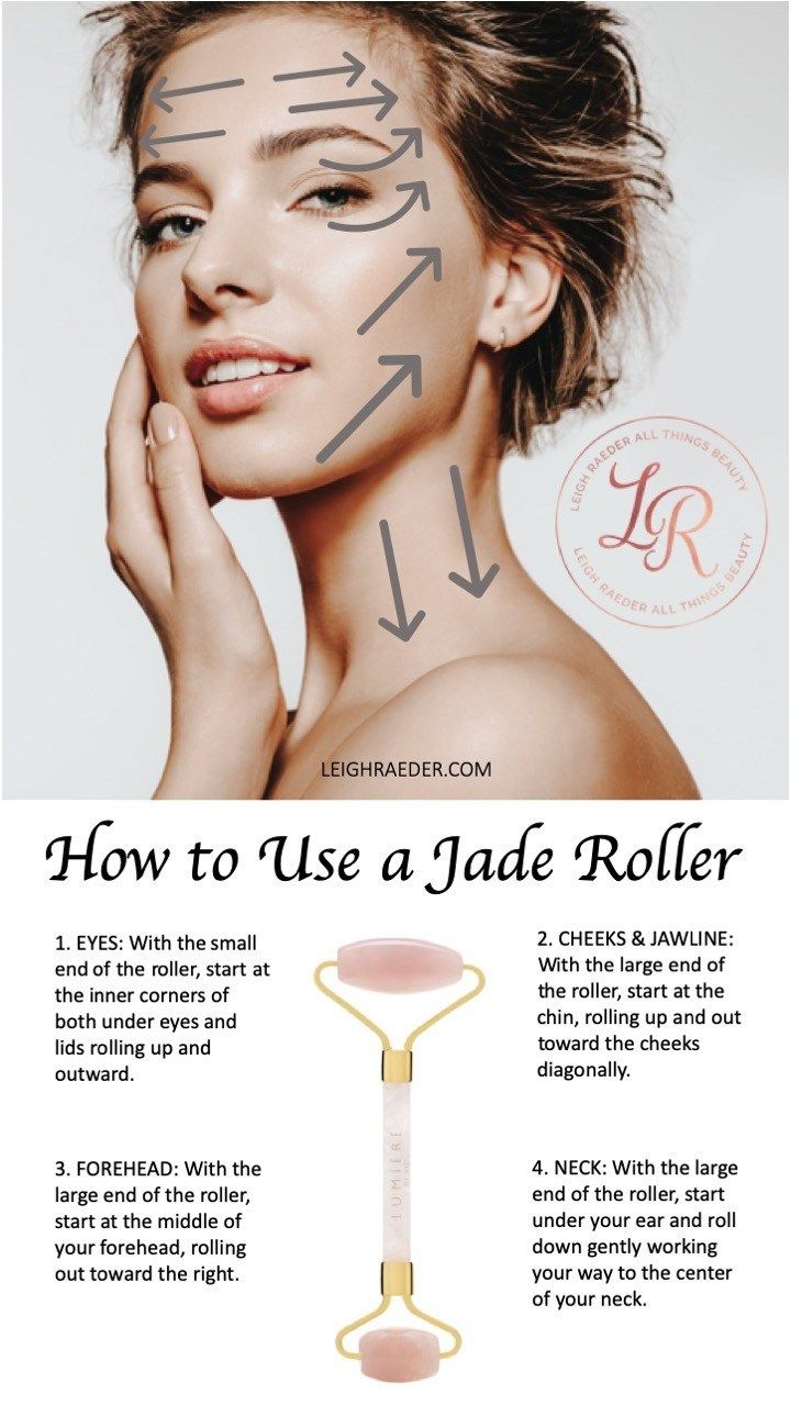 A woman at the gym using a jade roller on her face after a workout
