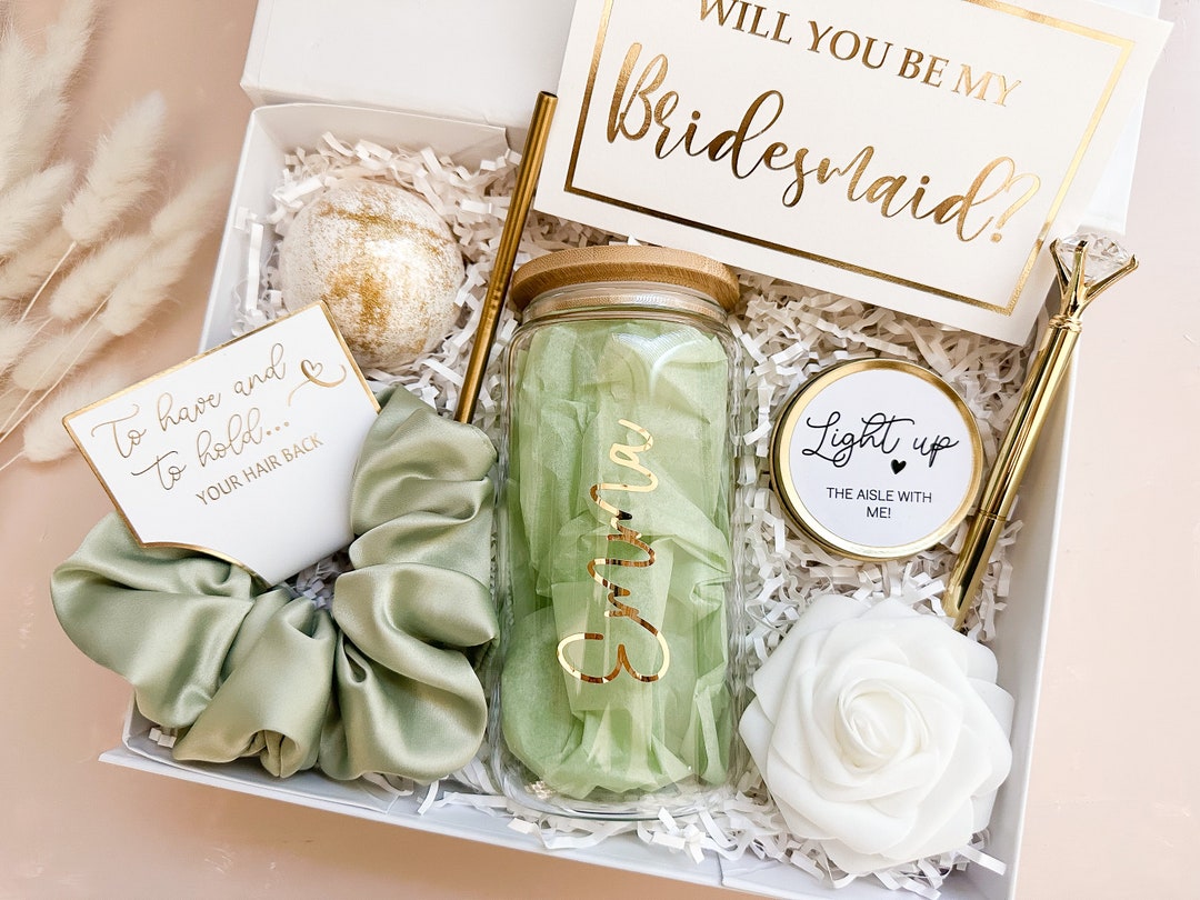 A bridesmaid proposal box with a jade roller and a card
