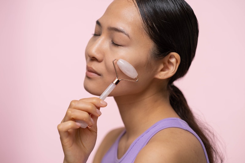 jade roller held lightly on the face