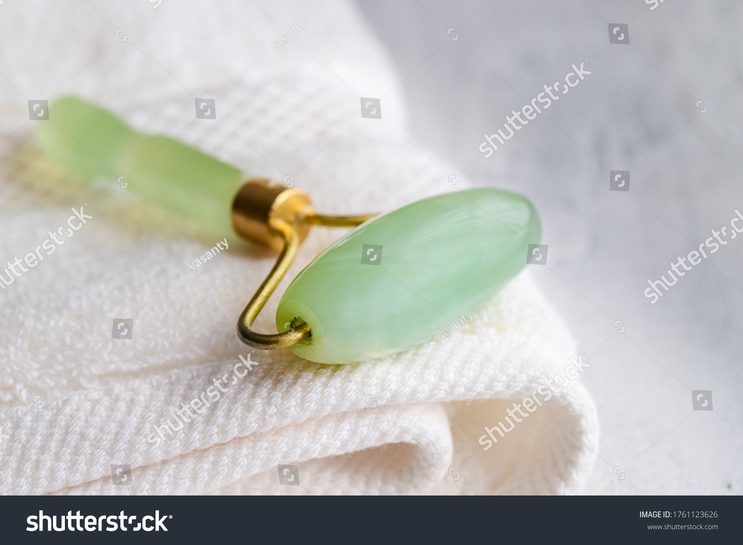 jade roller at side of neck for drainage