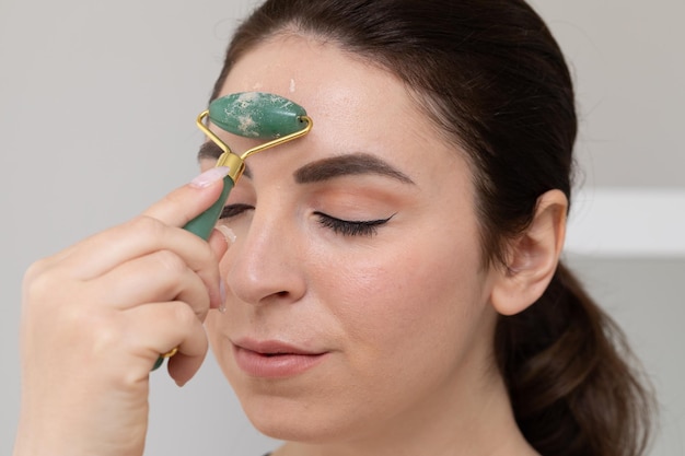 jade roller on forehead